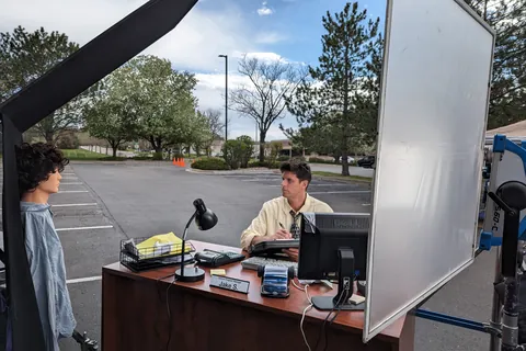 An office desk set built in a parking lot, between big light frames