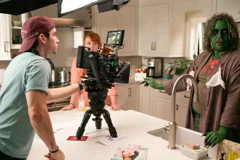 A camera operator lines up on the monster in a kitchen set