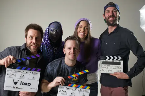 Cast and crew holding the slates on the Loxo shoot