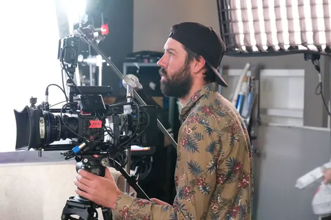 A camera operator lines up a shot